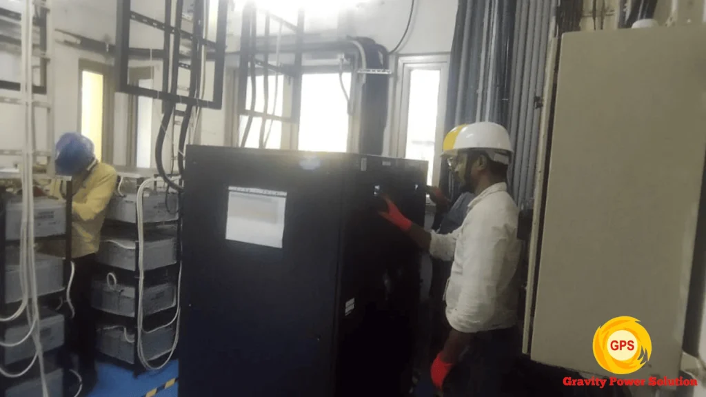Technicians installing and servicing industrial online UPS system at client site in Bangalore by Gravity Power Solution